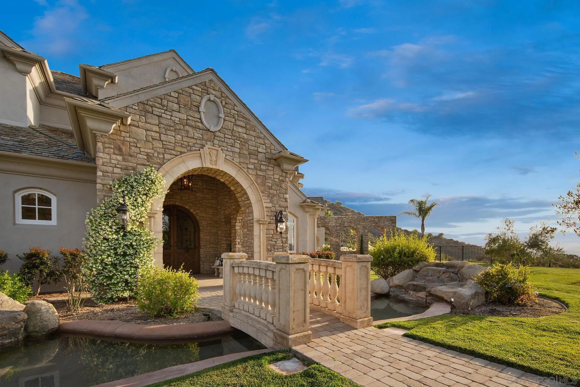 18781 Heritage Drive Poway, CA 92064 - Photo 3 of 69 a front view of a house with a garden