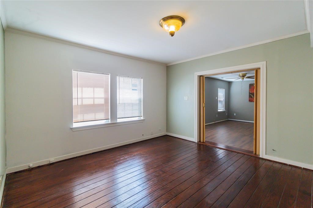1961 Dryden Road Houston, TX 77030 - Photo 11 of 33 an empty room with wooden floor and a window