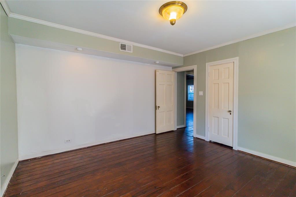 1961 Dryden Road Houston, TX 77030 - Photo 18 of 33 a view of an empty room with wooden floor and a window