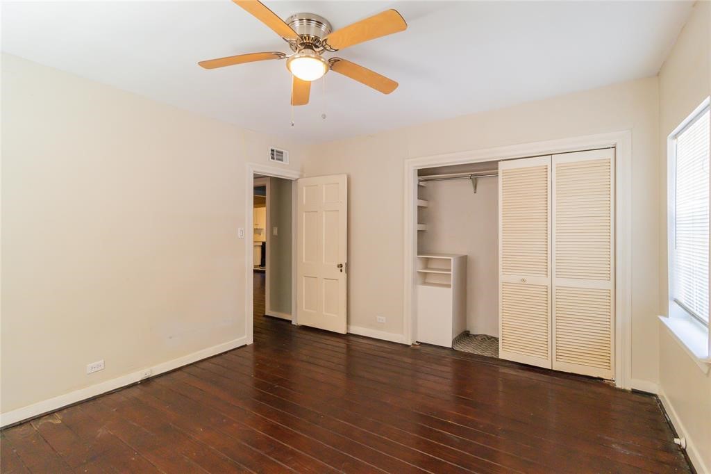 1961 Dryden Road Houston, TX 77030 - Photo 19 of 33 an empty room with wooden floor closet and windows