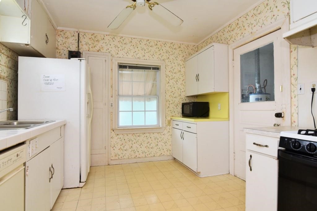 1961 Dryden Road Houston, TX 77030 - Photo 27 of 33 a view of a kitchen with white cabinets and black appliances