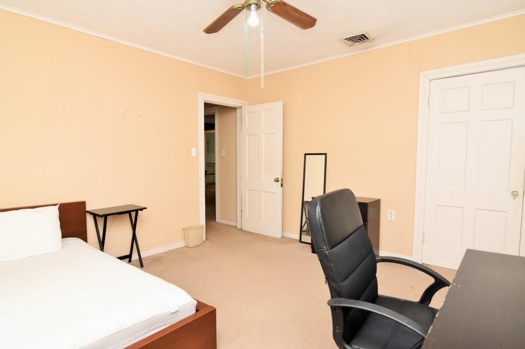 1961 Dryden Road Houston, TX 77030 - Photo 29 of 33 a bedroom with furniture and a window