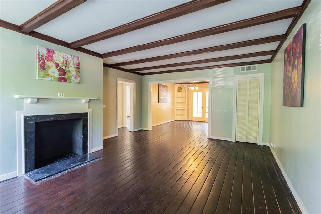 1961 Dryden Road Houston, TX 77030 - Photo 4 of 33 a view of an empty room with wooden floor fireplace and a window