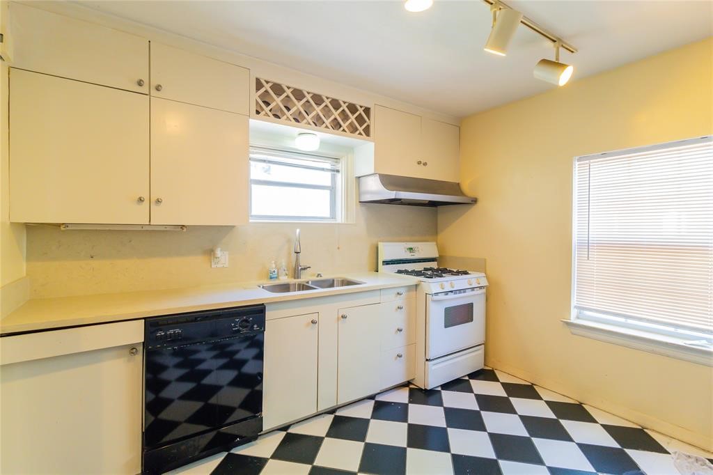 1961 Dryden Road Houston, TX 77030 - Photo 9 of 33 a kitchen with a stove a sink and a window
