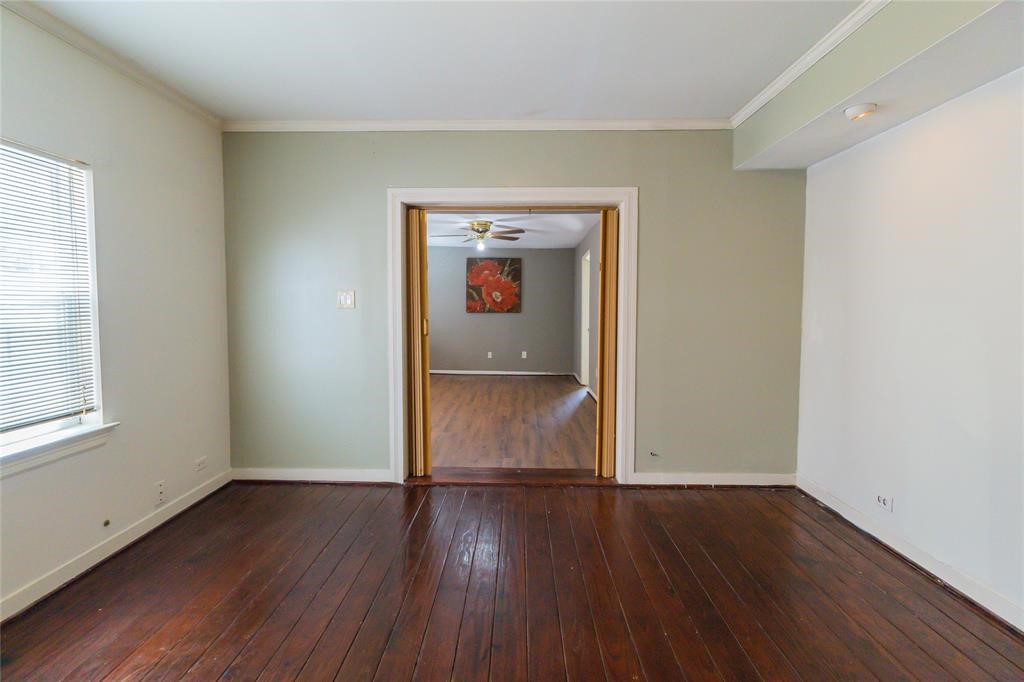 1961 Dryden Road Houston, TX 77030 - Photo 10 of 33 an empty room with wooden floor and windows