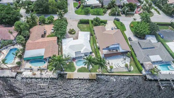 an aerial view of a house with garden space and street view