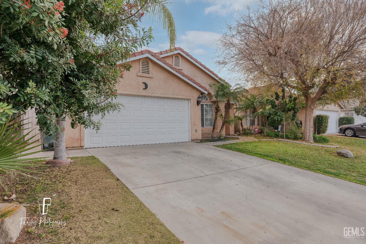 Undisclosed Address Bakersfield, CA 93313 - Photo 2 of 27 a front view of house with yard and trees