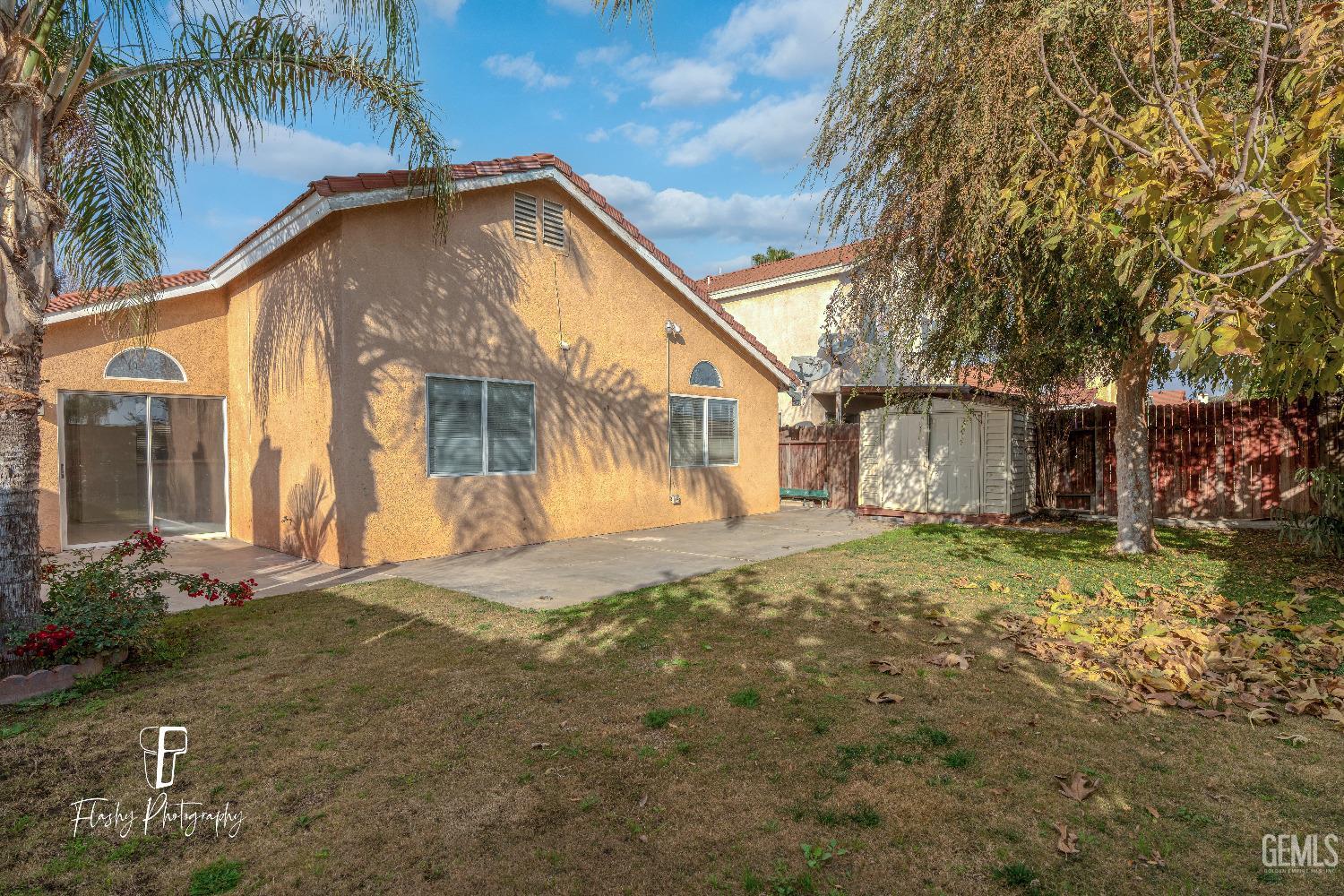 Undisclosed Address Bakersfield, CA 93313 - Photo 26 of 27 a front view of a house with a yard