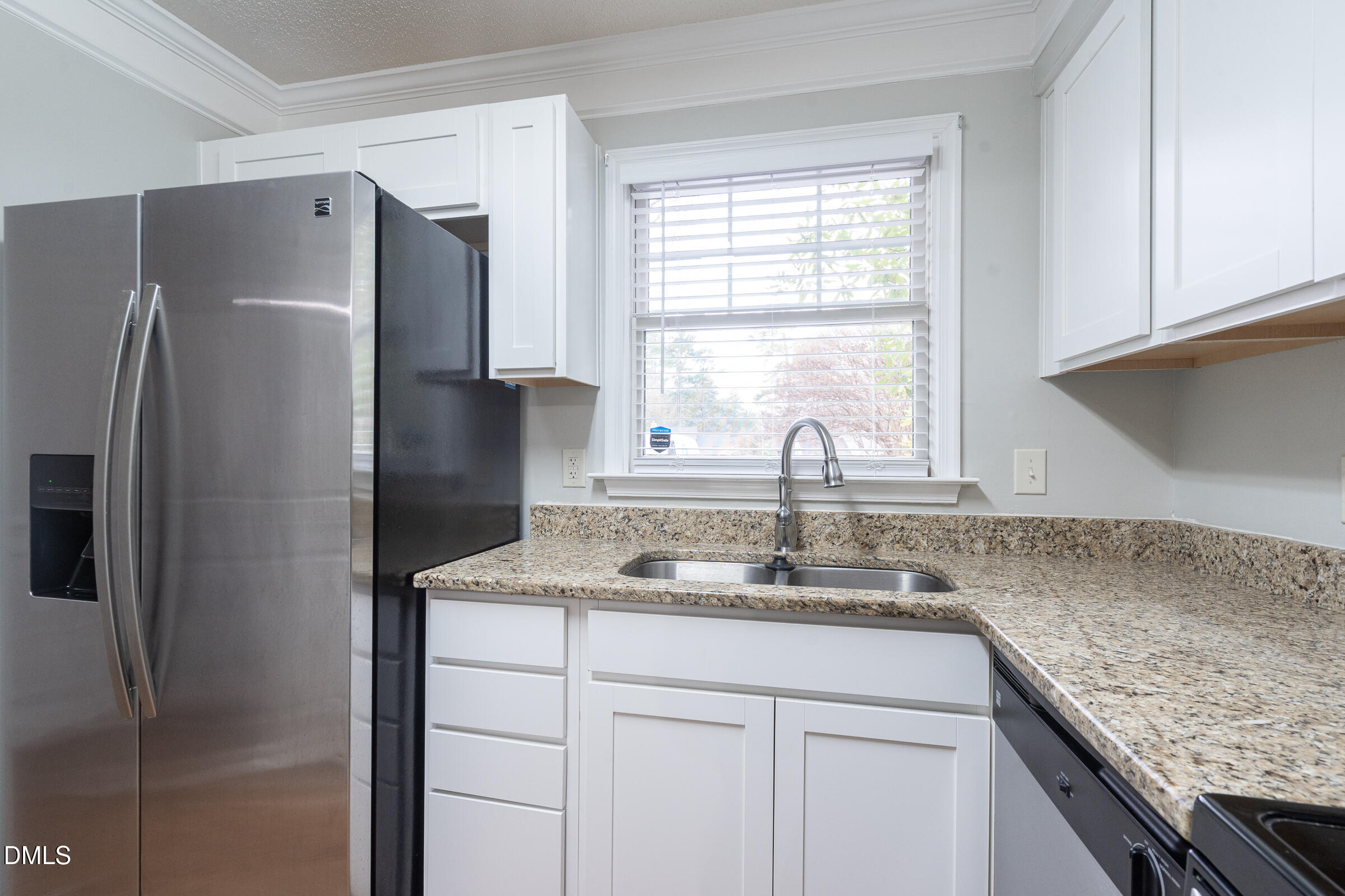 4418 Roller Court Raleigh, NC 27604 - Photo 7 of 16 a kitchen with stainless steel appliances granite countertop a refrigerator and a sink