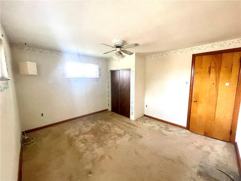 1010 5th Street Baden, PA 15005 - Photo 13 of 21 an empty room with a ceiling fan and a window