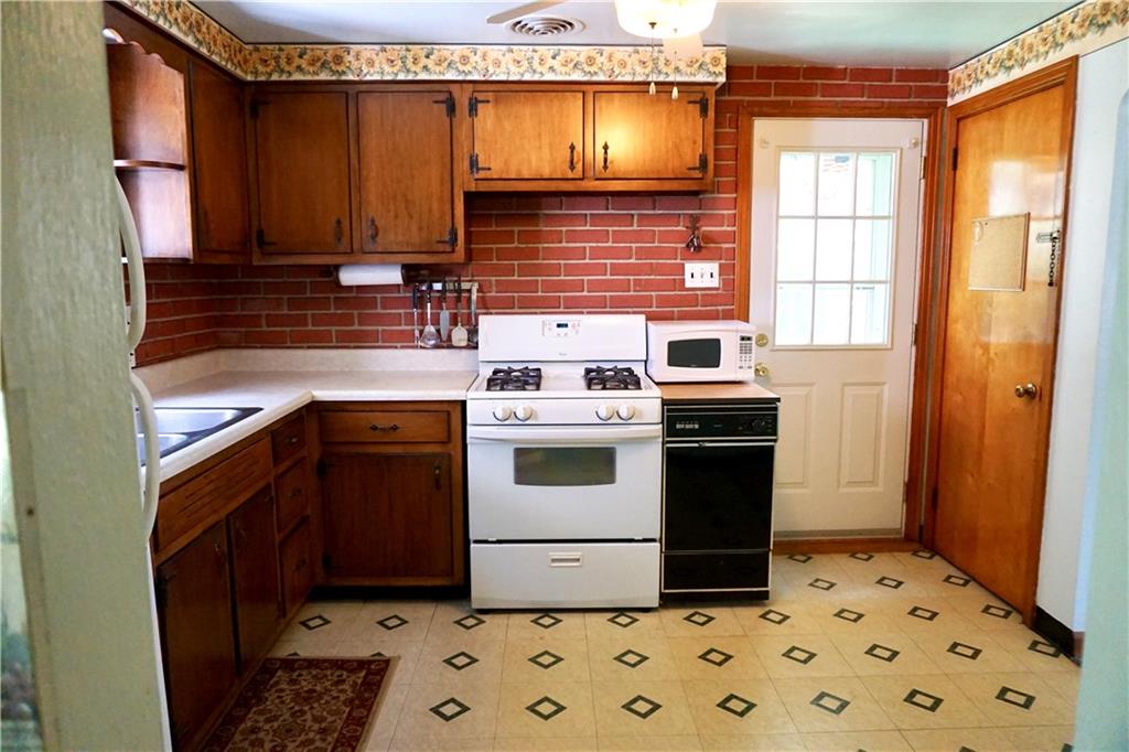 1010 5th Street Baden, PA 15005 - Photo 5 of 21 a kitchen with stainless steel appliances a stove a sink and a refrigerator