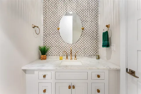 a bathroom with a double vanity sink and a bathtub