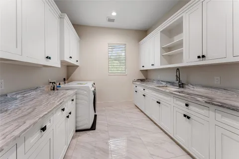 a view of an empty room with wooden floor and windows