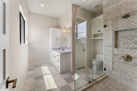 an empty room with a ceiling fan and windows