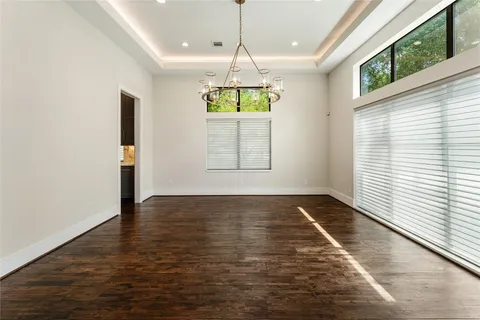 a large kitchen with stainless steel appliances a large counter top a stove and a refrigerator