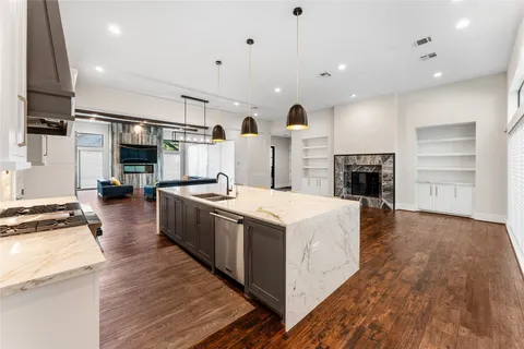 a large kitchen with stainless steel appliances granite countertop a large stove a sink and a refrigerator