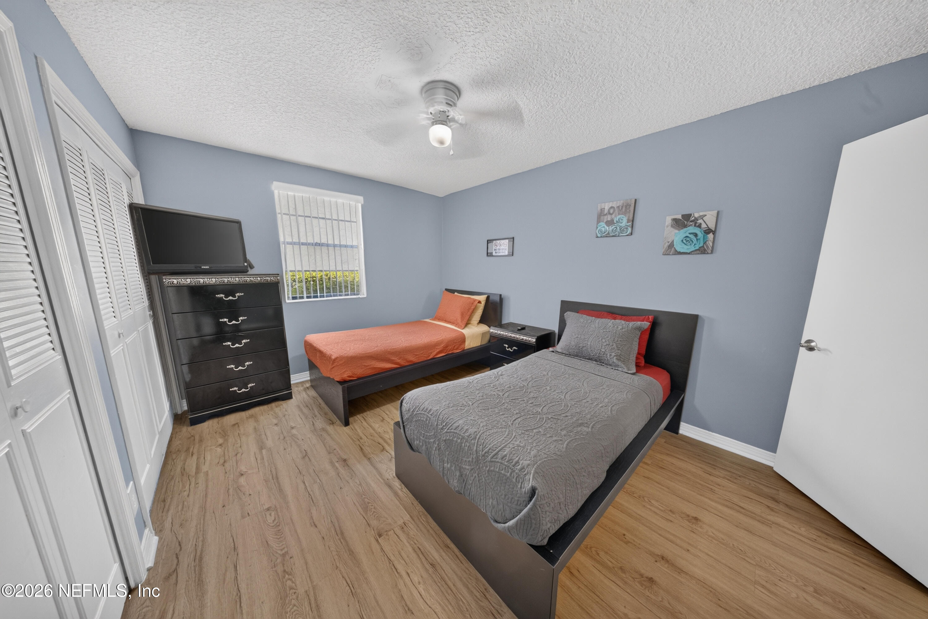 7346 El Barco Road, Unit 4 Jacksonville, FL 32216 - Photo 12 of 19 a bedroom with two beds and a flat screen tv