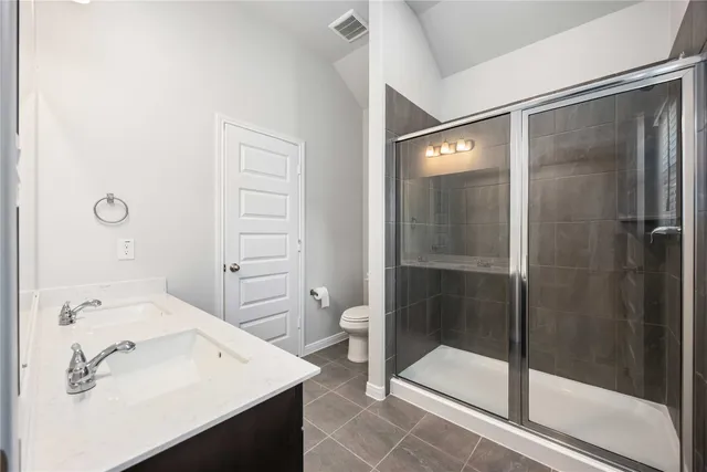 a bathroom with a shower sink and toilet