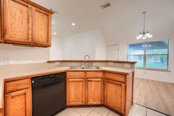 a kitchen with stainless steel appliances granite countertop a sink and cabinets with wooden floor