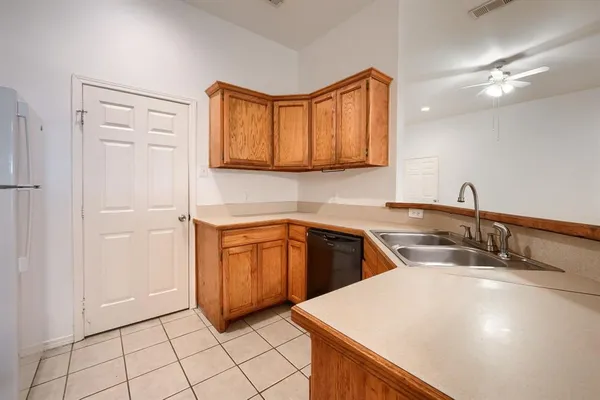 a kitchen with stainless steel appliances granite countertop a sink and a stove top oven