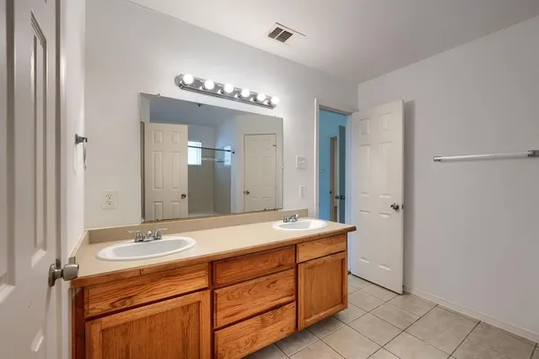 a bathroom with a sink double vanity and a mirror