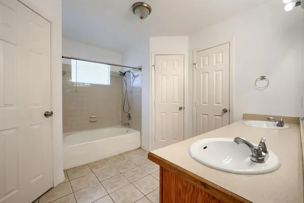 a bathroom with a sink a tub and a mirror