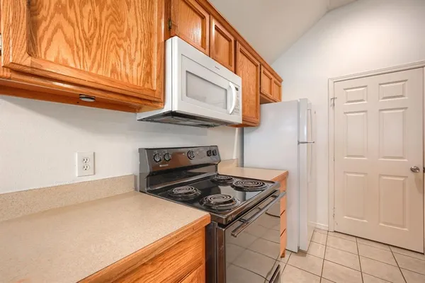 a kitchen with stainless steel appliances granite countertop a stove and a refrigerator