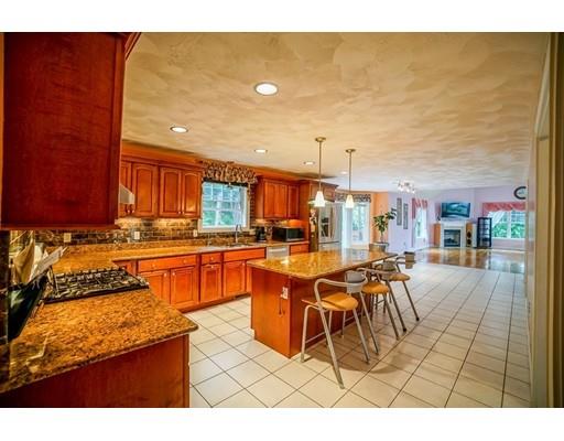 18 Cobblestone Way Billerica, MA 01862 - Photo 14 of 30 a kitchen with stainless steel appliances granite countertop a stove a sink and a microwave