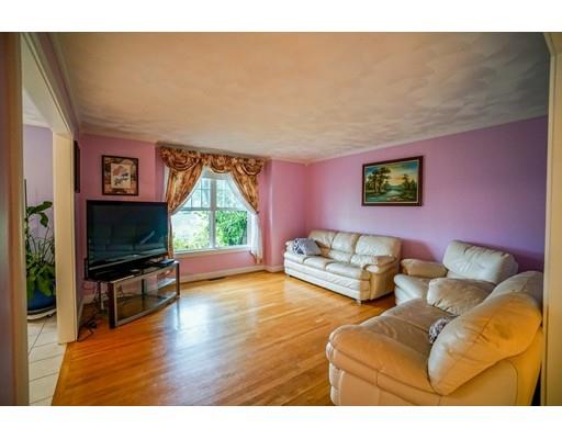 18 Cobblestone Way Billerica, MA 01862 - Photo 16 of 30 a living room with furniture a flat screen tv and a fireplace