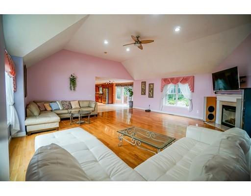 18 Cobblestone Way Billerica, MA 01862 - Photo 19 of 30 a living room with furniture a flat screen tv and a fireplace