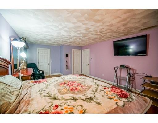 18 Cobblestone Way Billerica, MA 01862 - Photo 23 of 30 a bedroom with a bed and a flat screen tv