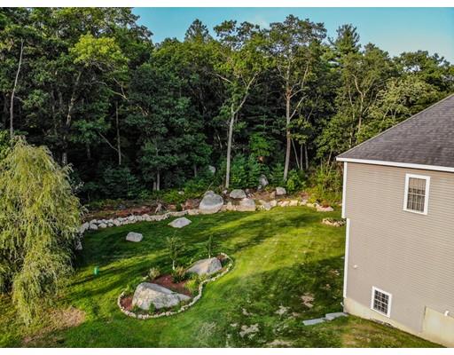 18 Cobblestone Way Billerica, MA 01862 - Photo 7 of 30 a backyard of a house with plants and outdoor seating