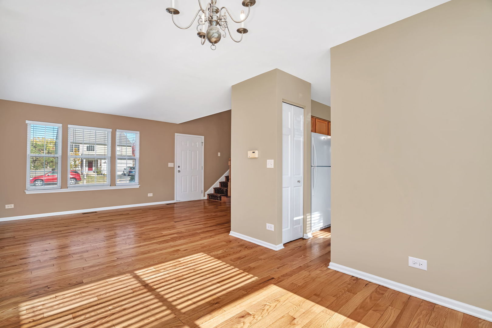 2509 Rosehall Lane Aurora, IL 60503 - Photo 11 of 51 an empty room with wooden floor and windows