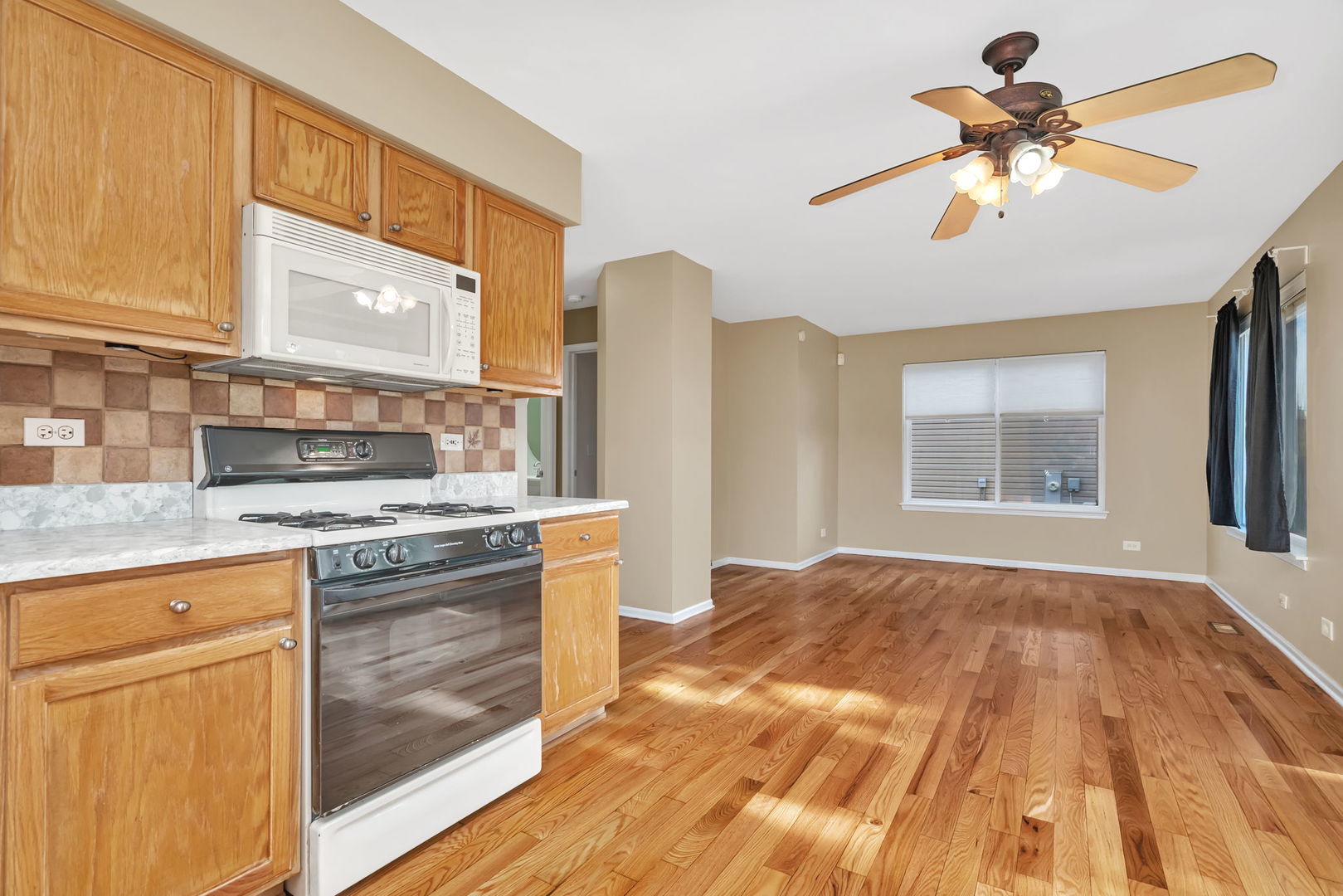 2509 Rosehall Lane Aurora, IL 60503 - Photo 15 of 51 a kitchen with a stove a sink and a refrigerator