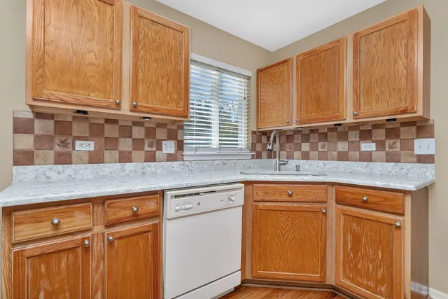 a kitchen with granite countertop cabinets sink and window