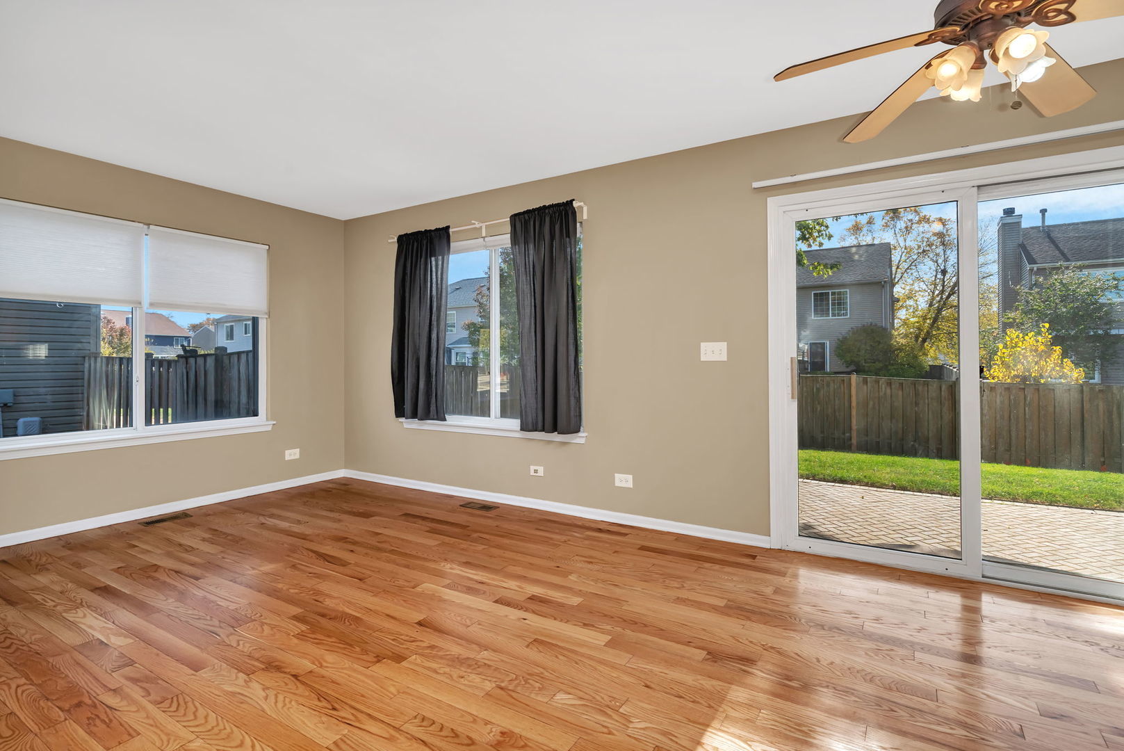 2509 Rosehall Lane Aurora, IL 60503 - Photo 20 of 51 a view of an empty room with wooden floor and a window