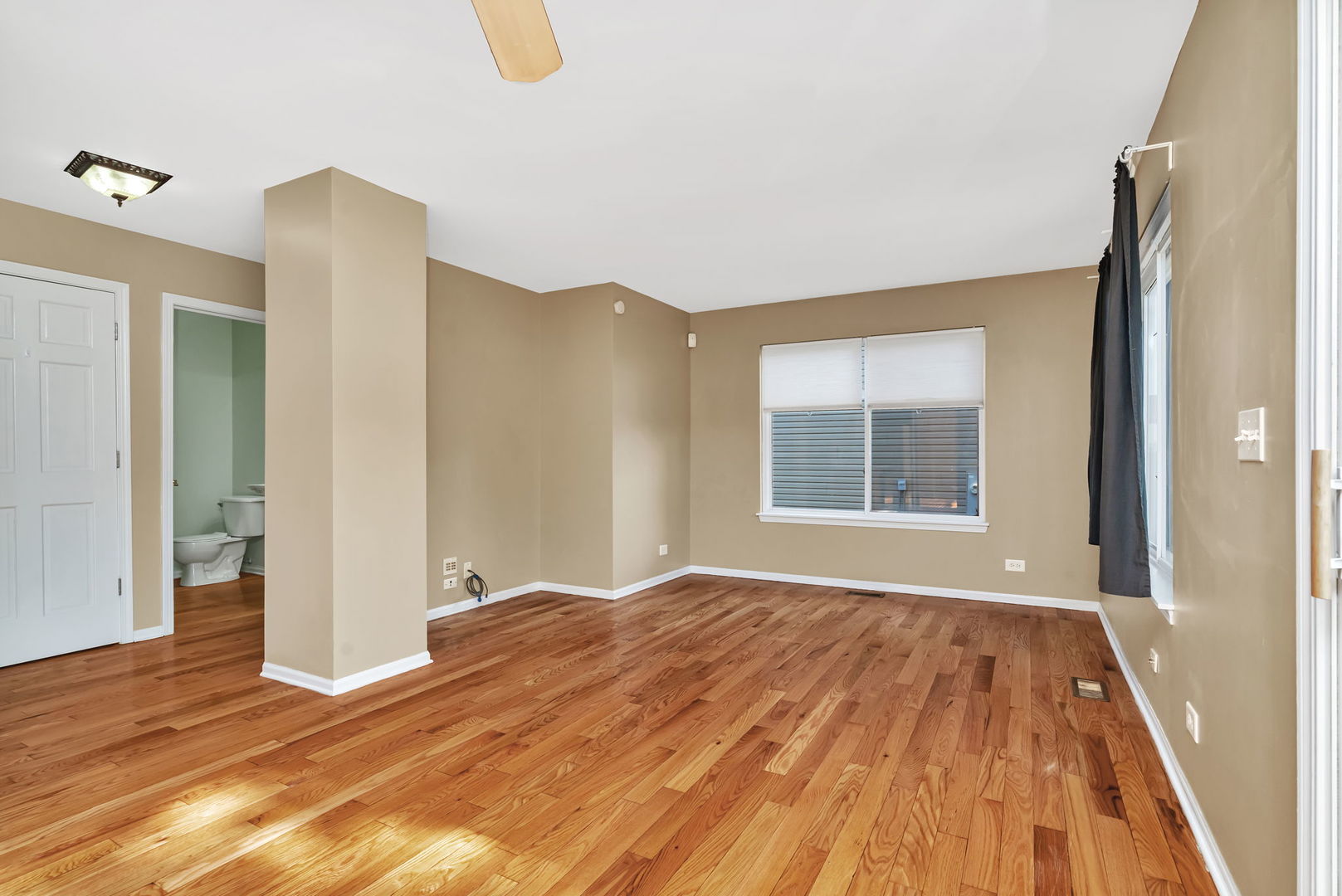 2509 Rosehall Lane Aurora, IL 60503 - Photo 21 of 51 a view of an empty room with wooden floor and a window