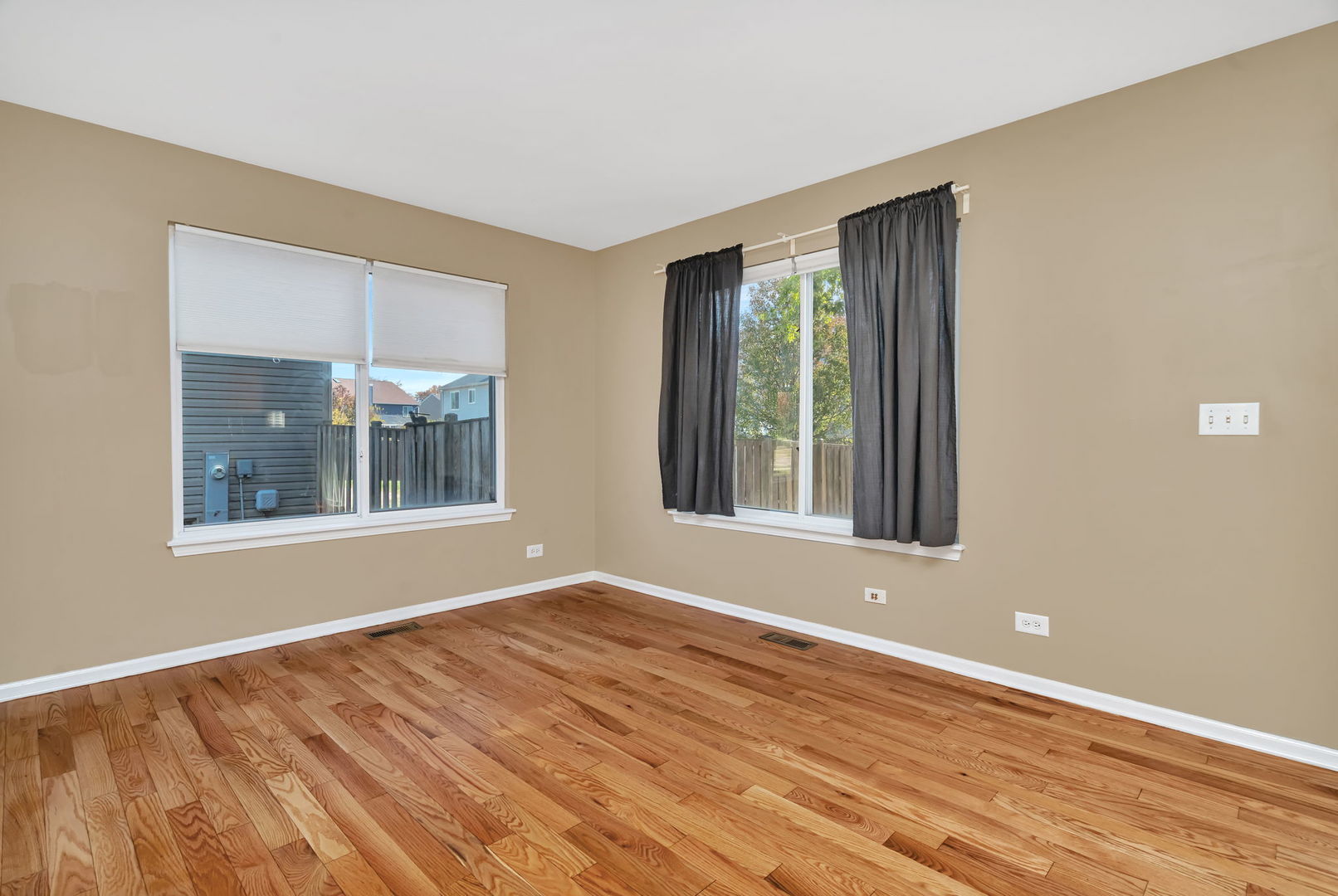 2509 Rosehall Lane Aurora, IL 60503 - Photo 22 of 51 a view of an empty room with wooden floor and a window