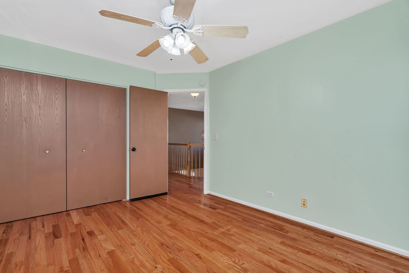 2509 Rosehall Lane Aurora, IL 60503 - Photo 33 of 51 an empty room with wooden floor chandelier fan and closet area