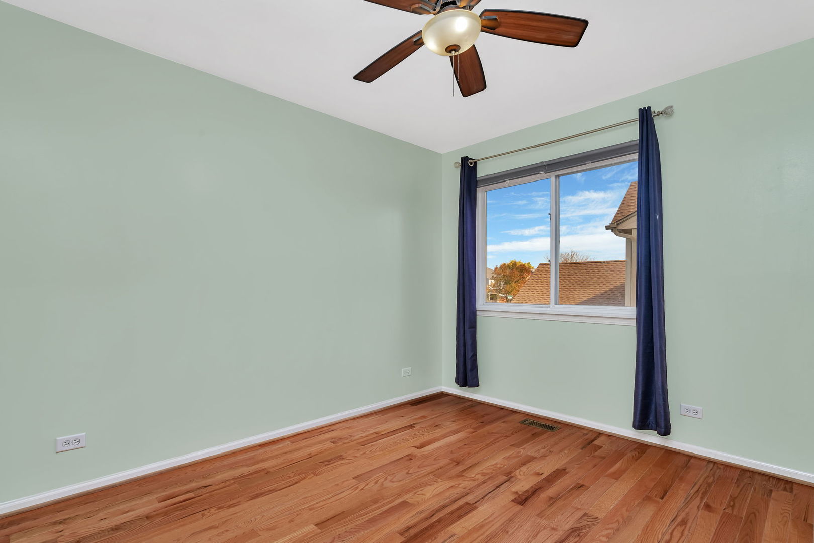 2509 Rosehall Lane Aurora, IL 60503 - Photo 34 of 51 an empty room with wooden floor ceiling fan and windows