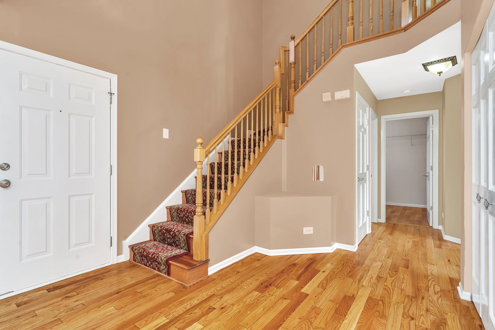 2509 Rosehall Lane Aurora, IL 60503 - Photo 4 of 51 a view of a hallway with wooden floor and staircase