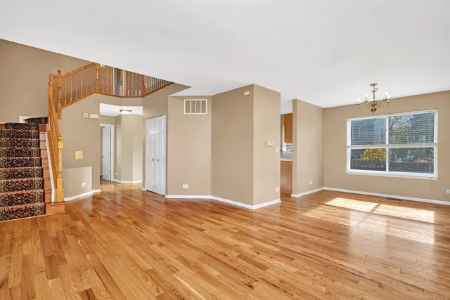 a view of a livingroom with wooden floor and windows