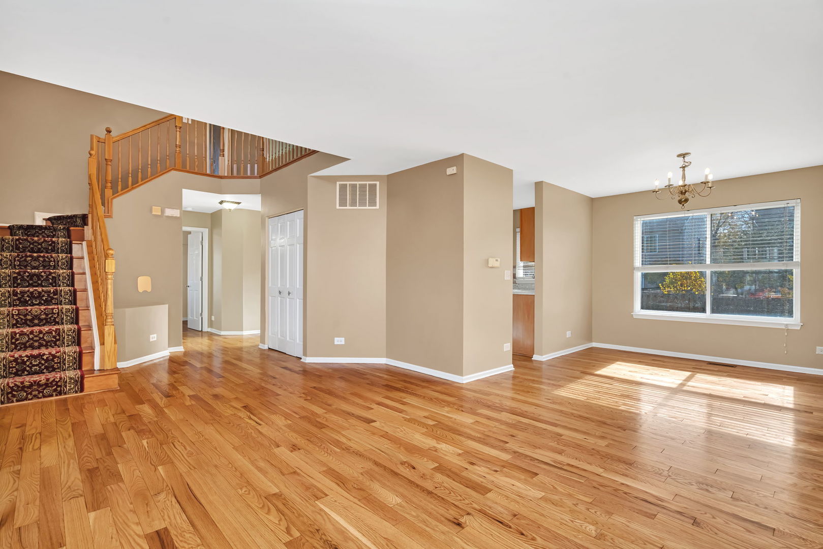 2509 Rosehall Lane Aurora, IL 60503 - Photo 9 of 51 a view of a livingroom with wooden floor and windows