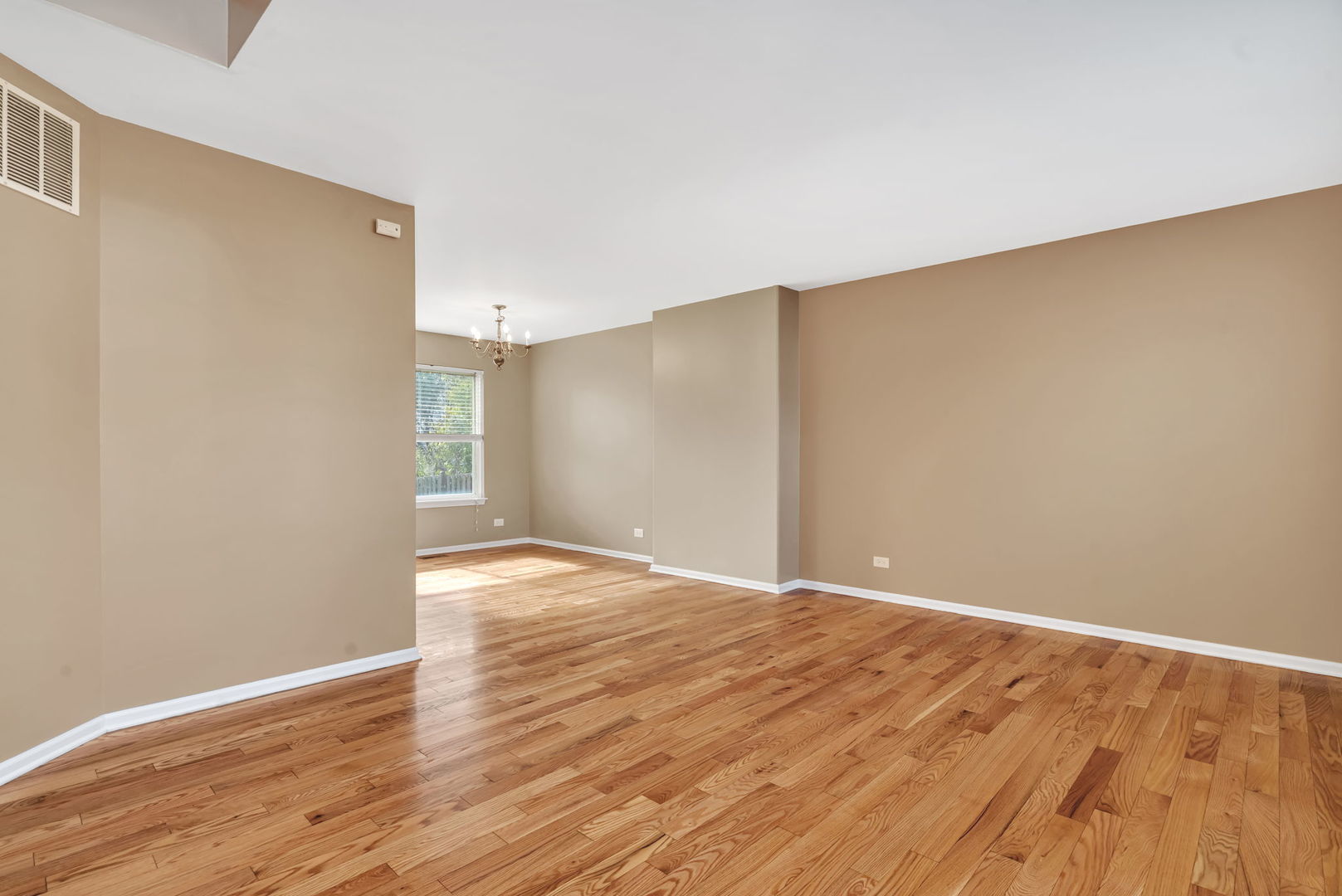2509 Rosehall Lane Aurora, IL 60503 - Photo 10 of 51 a view of an empty room with wooden floor
