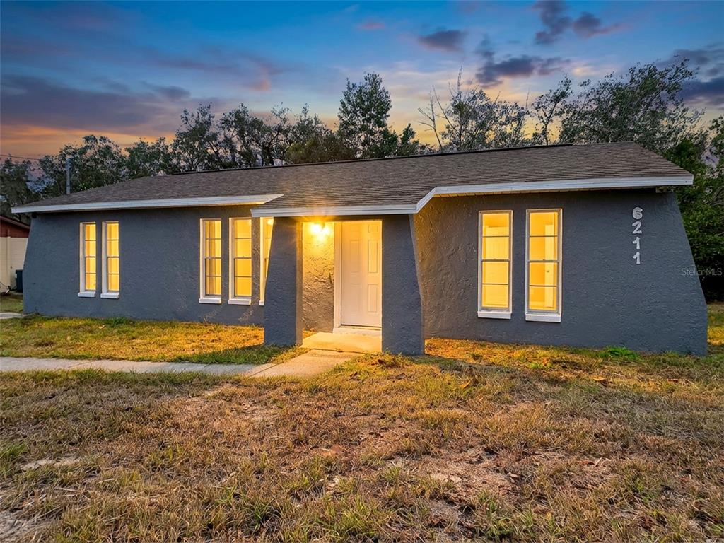 a view of a house with a yard