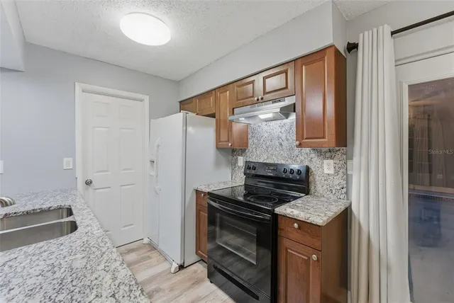 a kitchen with a stove and a sink
