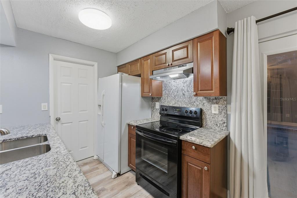 6211 Lorraine Lane Spring Hill, FL 34608 - Photo 13 of 28 a kitchen with a stove and a sink