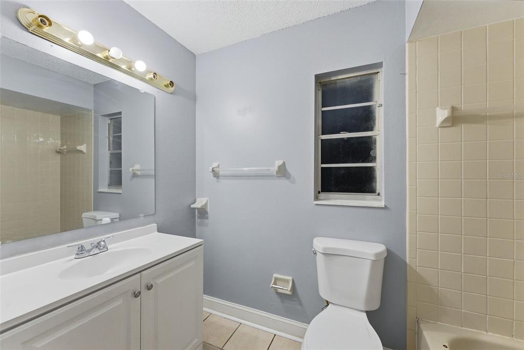6211 Lorraine Lane Spring Hill, FL 34608 - Photo 17 of 28 a bathroom with a toilet sink and mirror