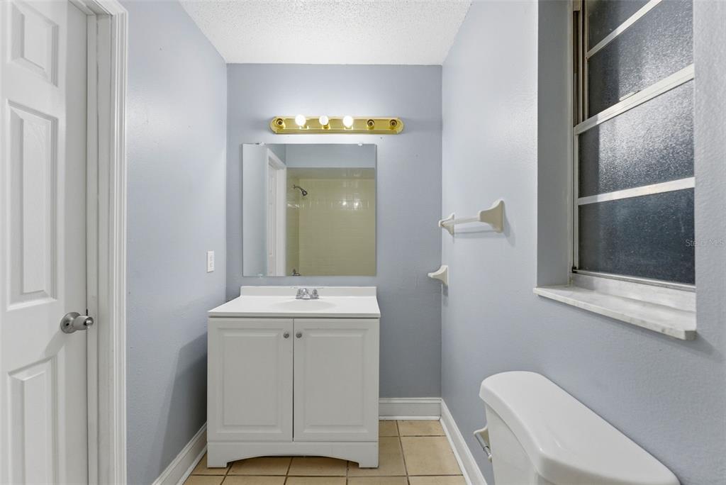 6211 Lorraine Lane Spring Hill, FL 34608 - Photo 18 of 28 a bathroom with a sink a toilet and shower