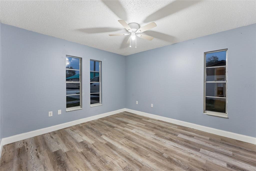 6211 Lorraine Lane Spring Hill, FL 34608 - Photo 20 of 28 a view of an empty room with a window and kitchen view